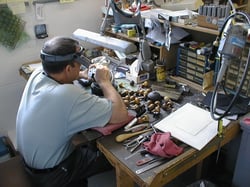 Master Hand Engraver cutting dies by hand